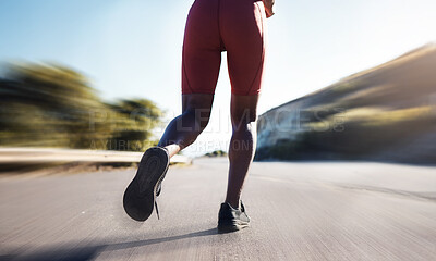 Buy stock photo Motion blur, woman and legs running on road for exercise, marathon workout and sports training. Back view, closeup and runner athlete with fast energy, fitness health and performance power outdoors