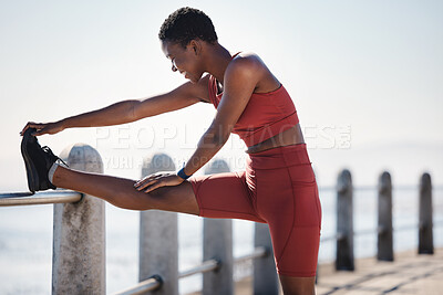 Buy stock photo Stretching, running and fitness with black woman at beach for workout, freedom and jogging. Summer, energy and peace with girl runner and warm up at sea promenade for cardio, endurance and training