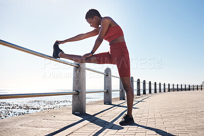 Buy stock photo Black woman, legs or fitness stretching by beach, ocean or sea for muscle pain relief, healthcare wellness or marathon ready. Runner, sports athlete or warm up exercise for promenade workout training