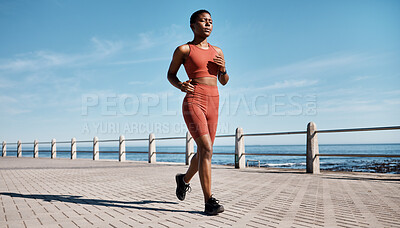 Buy stock photo Run, black woman and beach for workout, exercise and training for wellness, health and cardio. African American female, runner and athlete practice, fitness and endurance for marathon, race and ocean