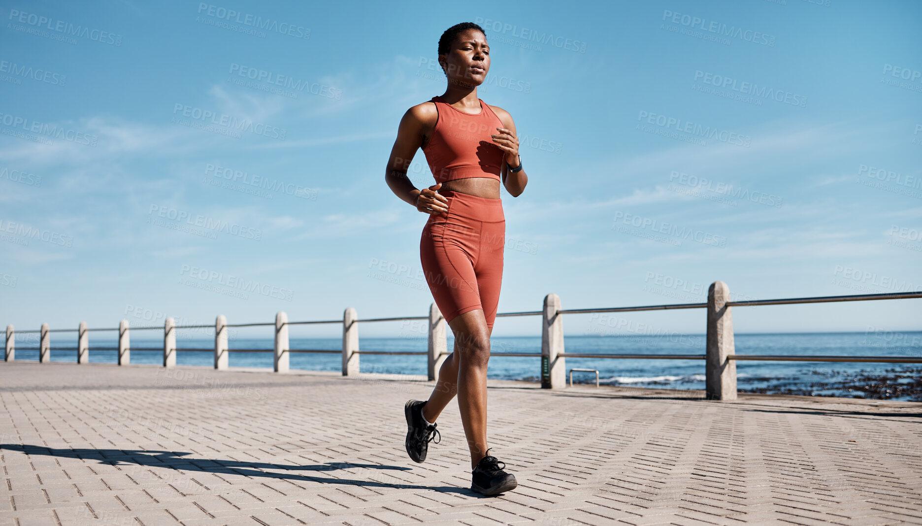 Buy stock photo Run, black woman and beach for workout, exercise and training for wellness, health and cardio. African American female, runner and athlete practice, fitness and endurance for marathon, race and ocean