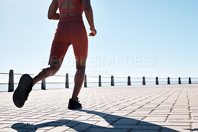 Buy stock photo Running, legs and promenade with a sports woman or runner outdoor for an exercise with blue sky mockup. Fitness, workout and shoes with a female athlete taking a run for cardio or endurance training