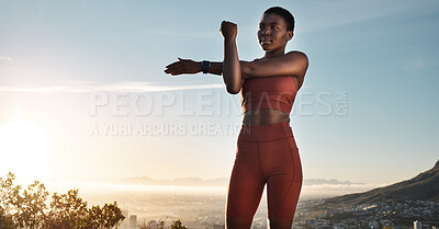 Buy stock photo Fitness, black woman and stretching arm on mountains, blue sky or sunset for wellness, healthy goals or energy. Focus, athlete and sports warm up, exercise and start body training with strong mindset