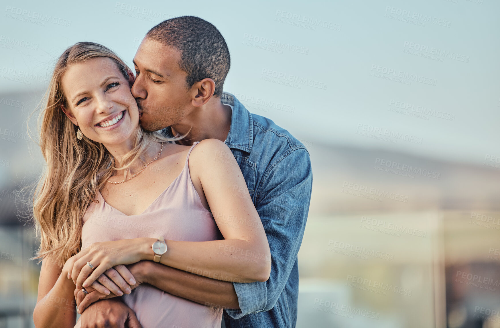 Buy stock photo Couple, hug and kiss for love, care or compassion in happy relationship, bonding or free time on mockup. Woman smiling with man kissing cheek and hugging in romantic quality bonding together outside