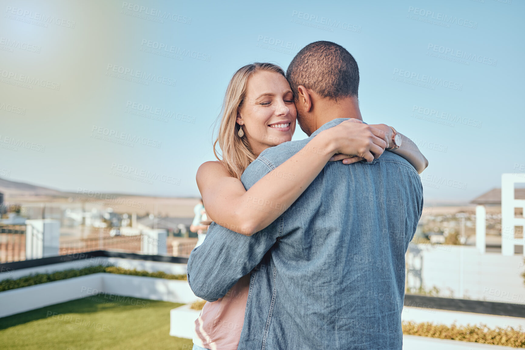 Buy stock photo Rooftop, love and couple hug in city enjoying summer holiday, weekend and vacation in Los Angeles. Romance, relationship and interracial man and woman embrace, bonding and hugging on urban adventure