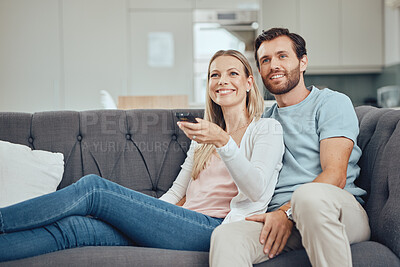 Buy stock photo Couple, home and watch television, happy on sofa with streaming movie or tv show, smile with remote control. Commitment, bond and love with routine, spending quality time in living room watching tv.