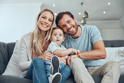 Buy stock photo Happy, smile and portrait of a family on a sofa relaxing, bonding and holding their child at their home. Mother, father and baby boy sitting in the living room together with love, care and happiness.