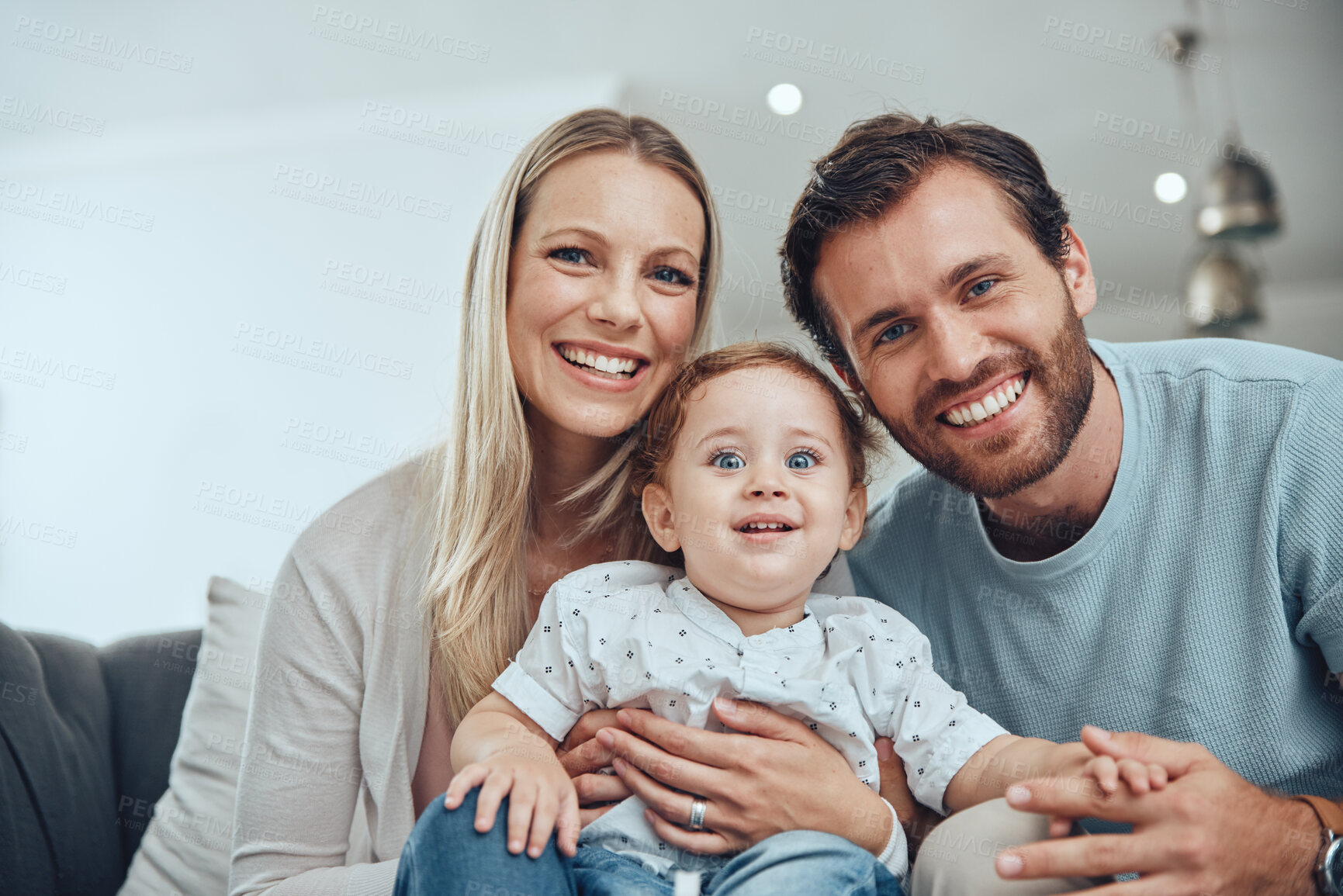 Buy stock photo Family, happy portrait and relax with baby on sofa in living room for love, support and quality time bonding. Parents smile, holding kid and happiness together for trust on couch in family home