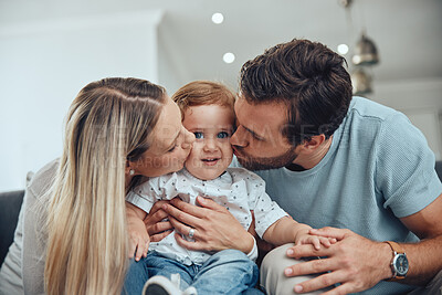 Buy stock photo Mom, dad and baby kiss on sofa in living room of happy family home, young parents and child together. Love, happiness and couple kissing kid with smile while sitting on couch in New York apartment.