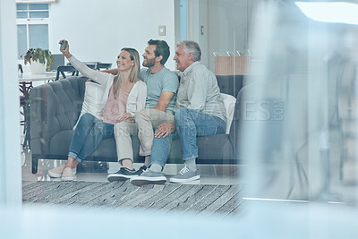 Buy stock photo Selfie, phone and happy family on a sofa in the living room relaxing and bonding in their modern home. Happiness, love and young couple taking a picture on a cellphone with a senior man in a lounge.