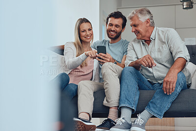 Buy stock photo Phone, relax and family on a sofa in the living room networking on social media, mobile app or the internet. Happy, smile and couple helping a senior man with his cellphone at his home in Canada.