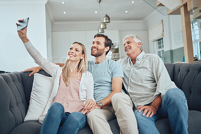 Buy stock photo Selfie, phone and happy family on a sofa in the living room relaxing and bonding in their modern home. Happiness, love and young couple taking a picture on a cellphone with a senior man in a lounge.