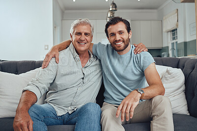 Buy stock photo Portrait of a senior man with his adult son relaxing on a sofa together in the living room. Happy, smile and elderly male pensioner in retirement sitting and bonding with a young guy in family home.