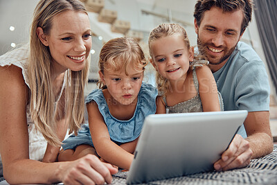 Buy stock photo Family, children and tablet with a girl, sister and parents watching tv on the living room floor together. App, kids or subscription with a mother, father and daughter siblings bonding at home