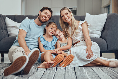 Buy stock photo Happy, smile and portrait of a family in living room relaxing, bonding and spending free time together. Mother, father and girl children sitting on floor with love, care and happiness in family home.