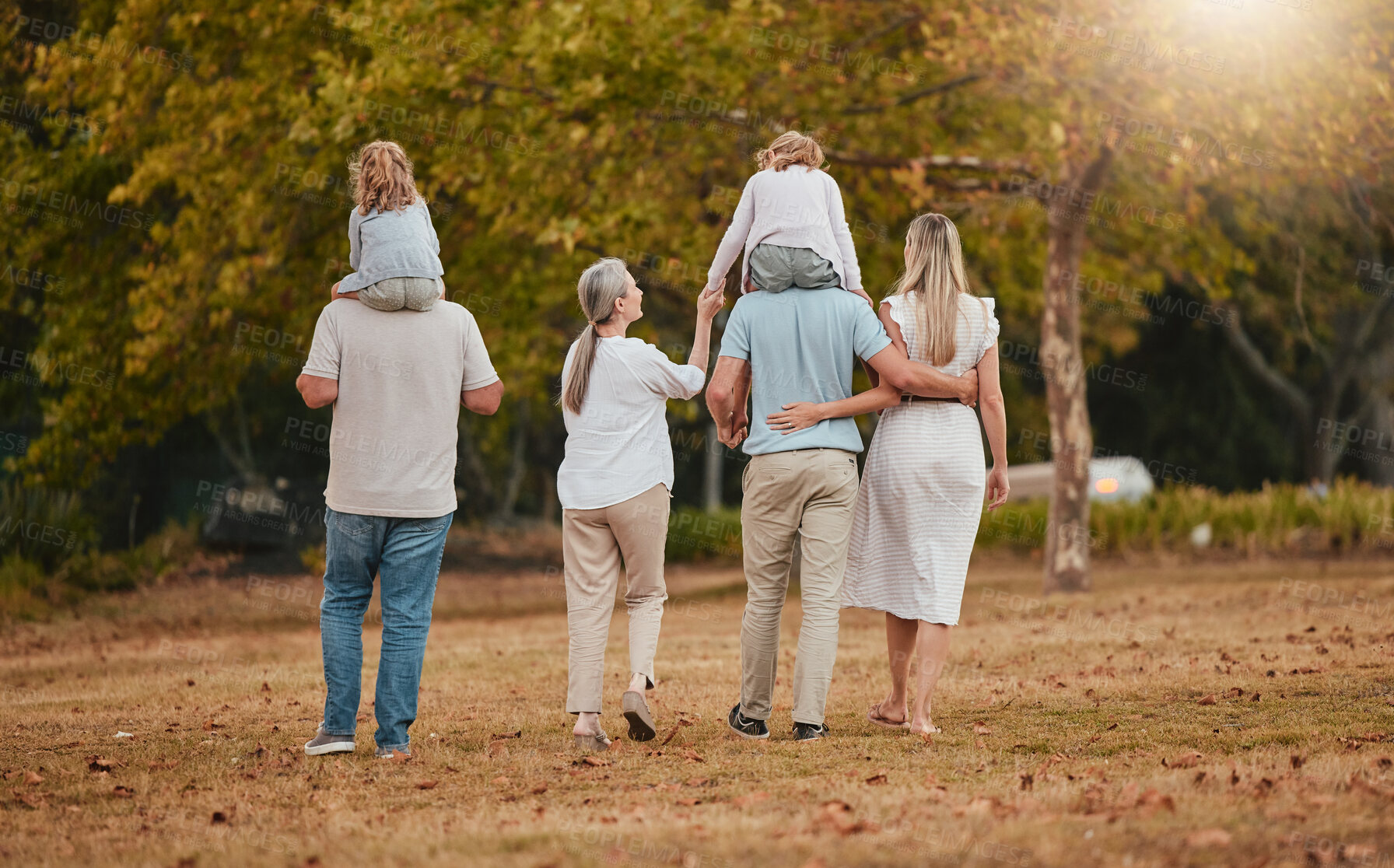 Buy stock photo Big family, park and nature walking of mother, grandparent and children with love and care. Happy family, outdoor and autumn field walk on vacation with grandmother, dad and girl back together