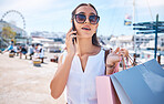 Woman, shopping bag and phone call in city for fashion discounts, shopper communication and retail customer with sunglasses. Mobile conversation, networking and girl shopping in outdoor street market