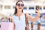 Phone, shopping or woman taking selfie for a social media profile picture in of city of Las Vegas on summer holiday. Fashion, content creator or happy girl influencer smiles with luxury shopping bag