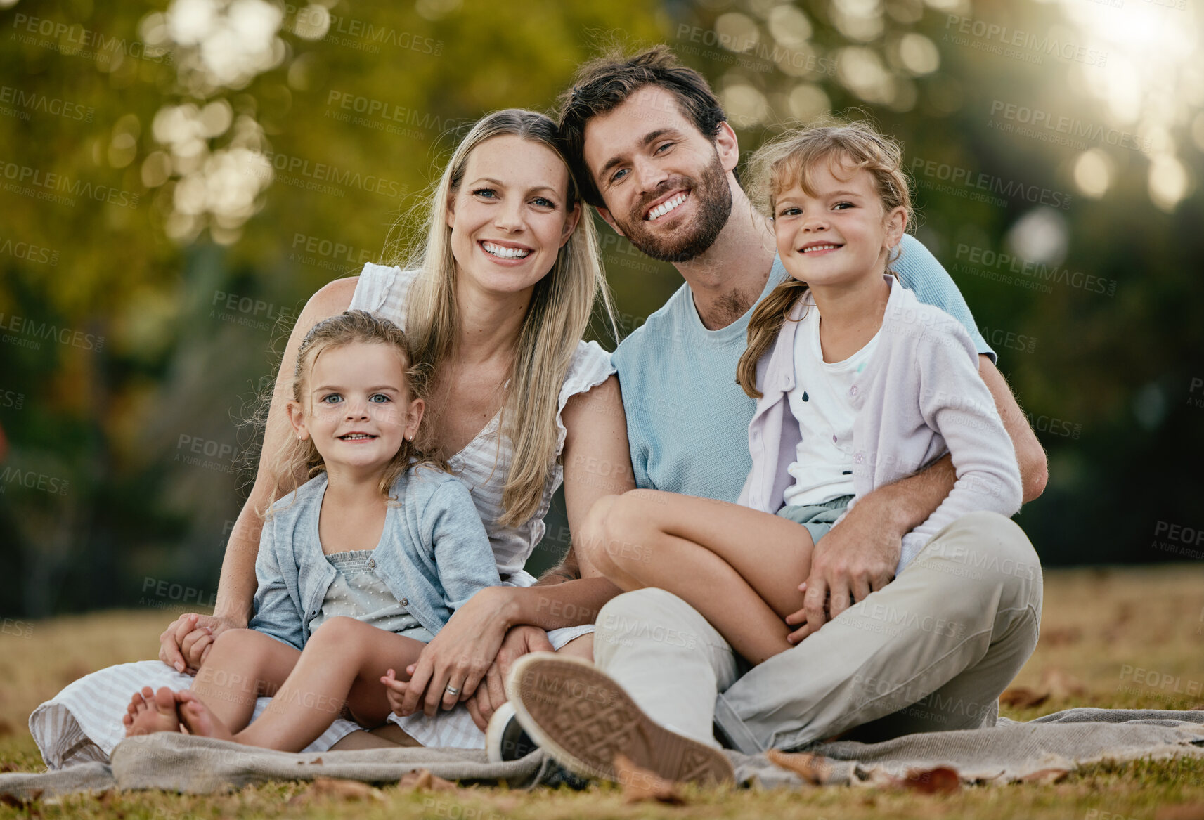 Buy stock photo Family, park picnic and portrait with smile, love and happiness for bonding on blanket, grass and sunshine. Young happy family, lawn and parents with kids, trees and relax together for summer holiday