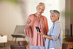 Senior women, phone and friends in home on social media, internet browsing or texting. Tech, cellphone and retired, elderly and happy females web scrolling with mobile smartphone together in house.