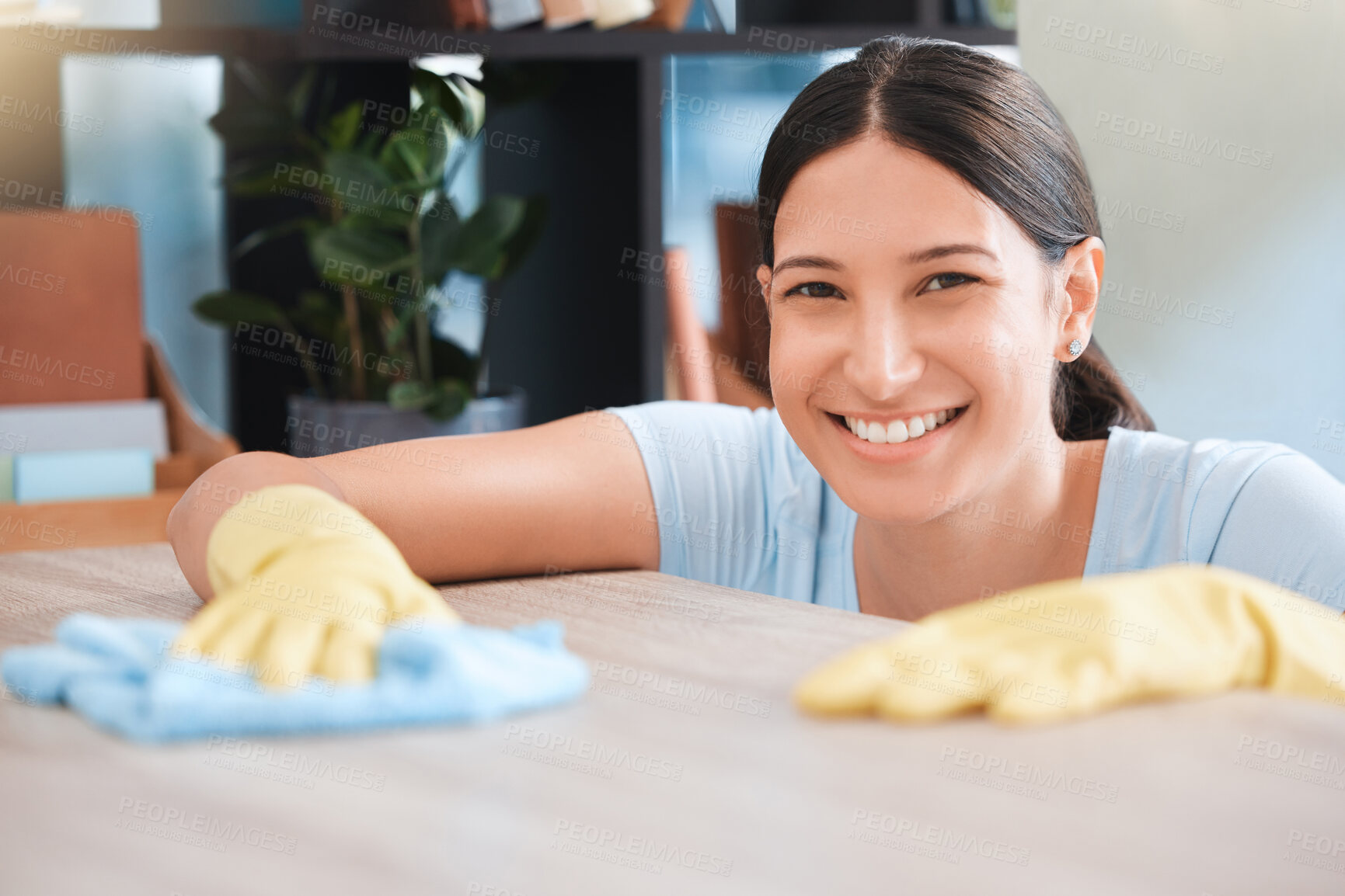 Buy stock photo Cleaning, woman or portrait happy cleaner with cloth and gloves for dusty, messy or dirty bacteria on wooden table. Smile, cleaning service or girl wipes germs furniture surface in home office room