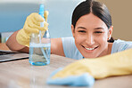 Happy, product or woman cleaning a table or wooden furniture with cloth, gloves and liquid soap in spray bottle. Smile, cleaning services or cleaner wipes dusty bacteria or dirty mess in living room