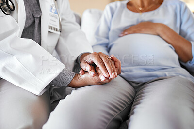 Buy stock photo Healthcare, doctor sitting and holding hands with pregnant woman on sofa for care, trust and support in medicine. Gynecologist, woman and pregnancy, helping hands encourage new mother with empathy.