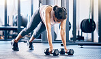 Dumbbell, fitness and training with woman in gym and push up for health, performance and challenge. Workout, wellness and strong with girl athlete and ground exercise for muscle, endurance and energy