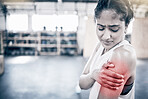Woman, fitness and shoulder pain in gym for exercise workout, training accident and sports medical emergency. Sad athlete, arm injury and physical therapy, arthritis or muscle wellness in health club
