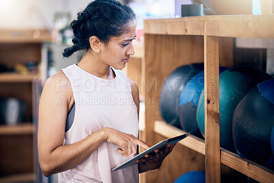 Buy stock photo Woman, gym and tablet for equipment inspection, or and  balls for training, workout or exercise. Fitness club manager, digital tech planning or personal trainer for wellness management in workplace
