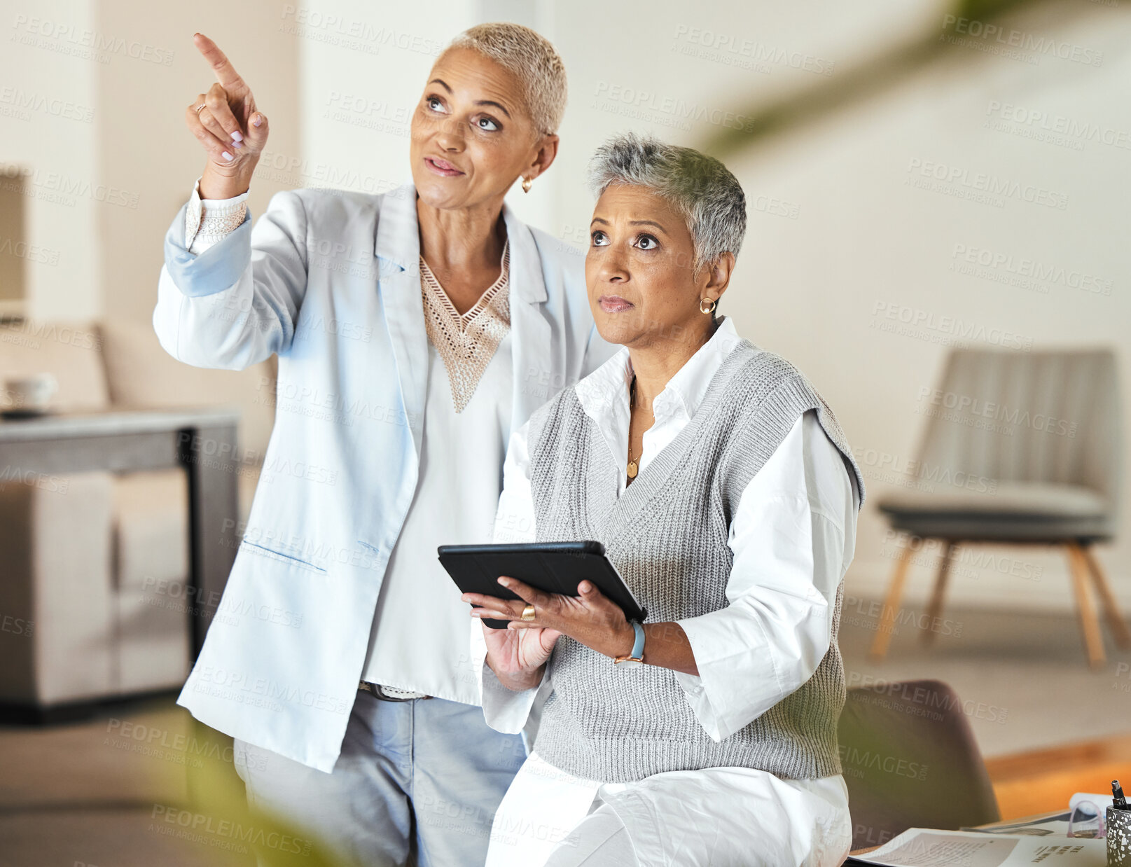 Buy stock photo Tablet, pointing and senior business women in office looking at research. Technology, teamwork and elderly female employees with touchscreen for planning advertising, sales and marketing strategy.