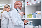 Pharmacy, stock and digital tablet for inventory by man and woman checking medicine and packing shelves. Pharmacist, senior man and online search on device app for information, prescription and pills