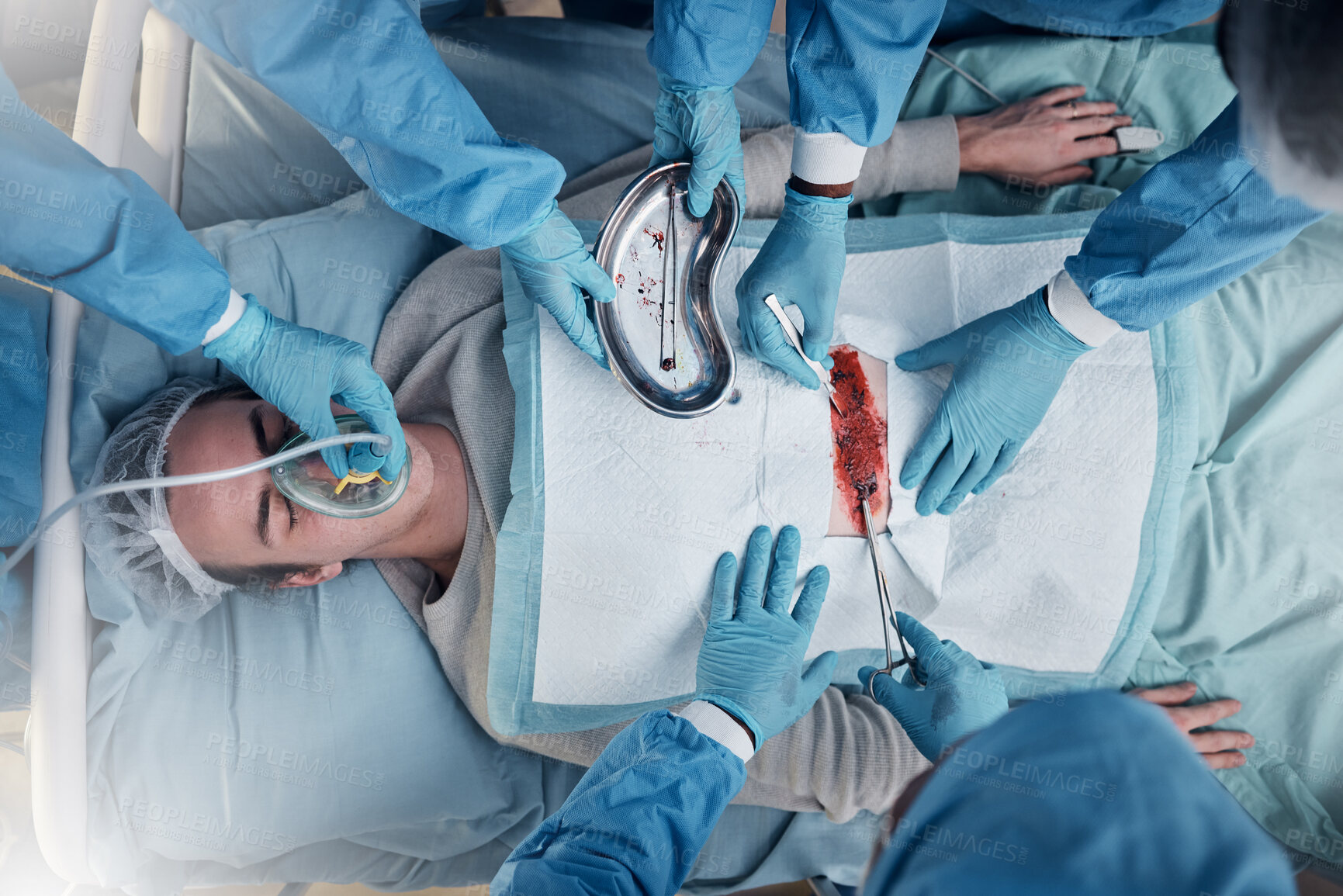 Buy stock photo Doctors, surgery and collaboration with a medicine team in scrubs operating on a man patient in a hospital. Doctor, nurse and teamwork with a medical group in a clinic to perform an operation