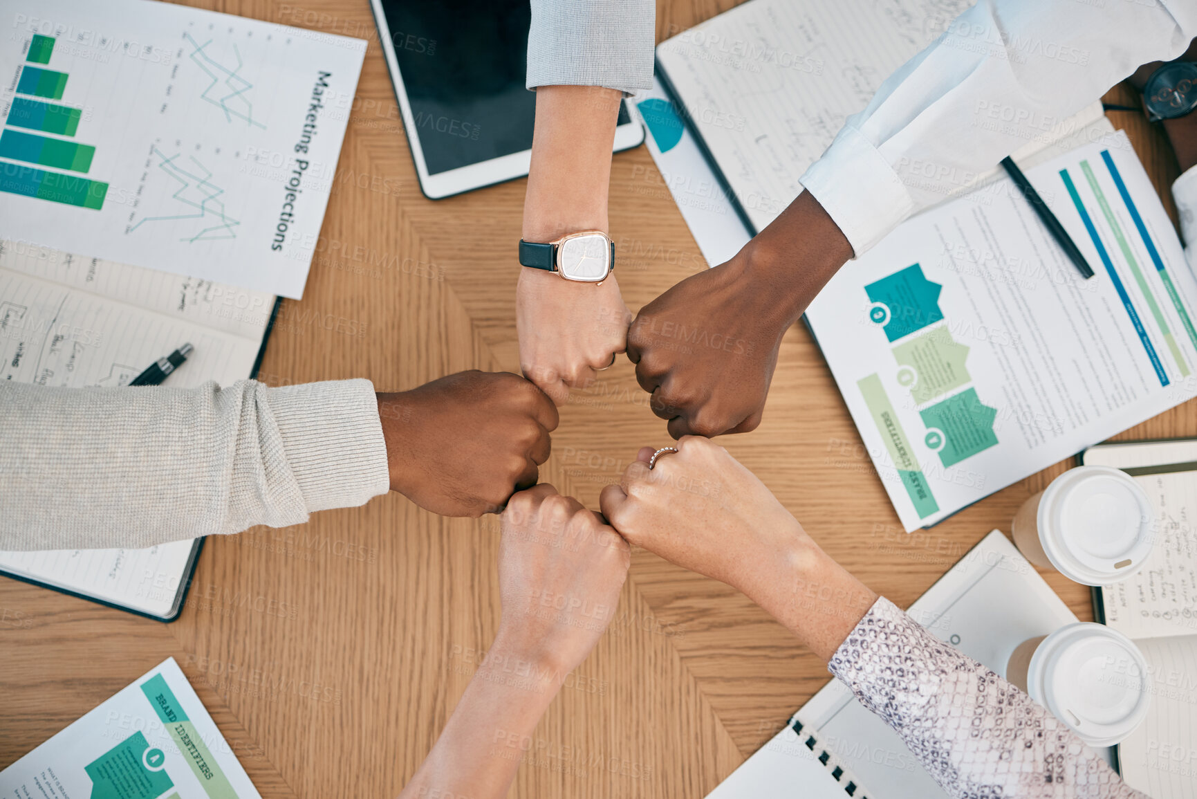 Buy stock photo Diversity, fist hands and teamwork with documents on table for marketing business meeting, creative collaboration and goals support motivation. Team, circle hand and planning strategy or logistics
