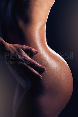 Buy stock photo Body, beauty and nude with a model woman posing sexy or seductive in studio on a dark background. Art, naked and sensual with an attractive young female standing to promote erotic or sexual freedom