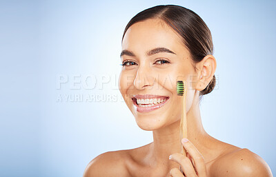 Buy stock photo Face portrait, dental and woman with toothbrush in studio isolated on a blue background. Oral wellness, veneers and happy female model holding product for brushing teeth, cleaning and oral hygiene.