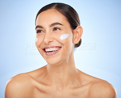 Buy stock photo Face, beauty skincare and woman with cream in studio isolated on a blue background. Thinking, cosmetics and female model apply facial lotion, creme and moisturizer product for healthy skin hydration.