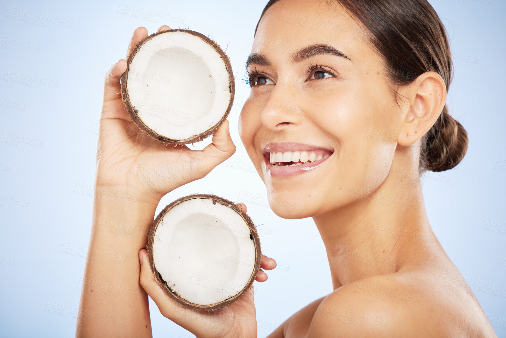 Buy stock photo Skincare, wellness and face of woman with coconut on blue background for dermatology, body care and beauty. Spa, salon and girl with fruit for natural beauty products, cosmetics and facial treatment