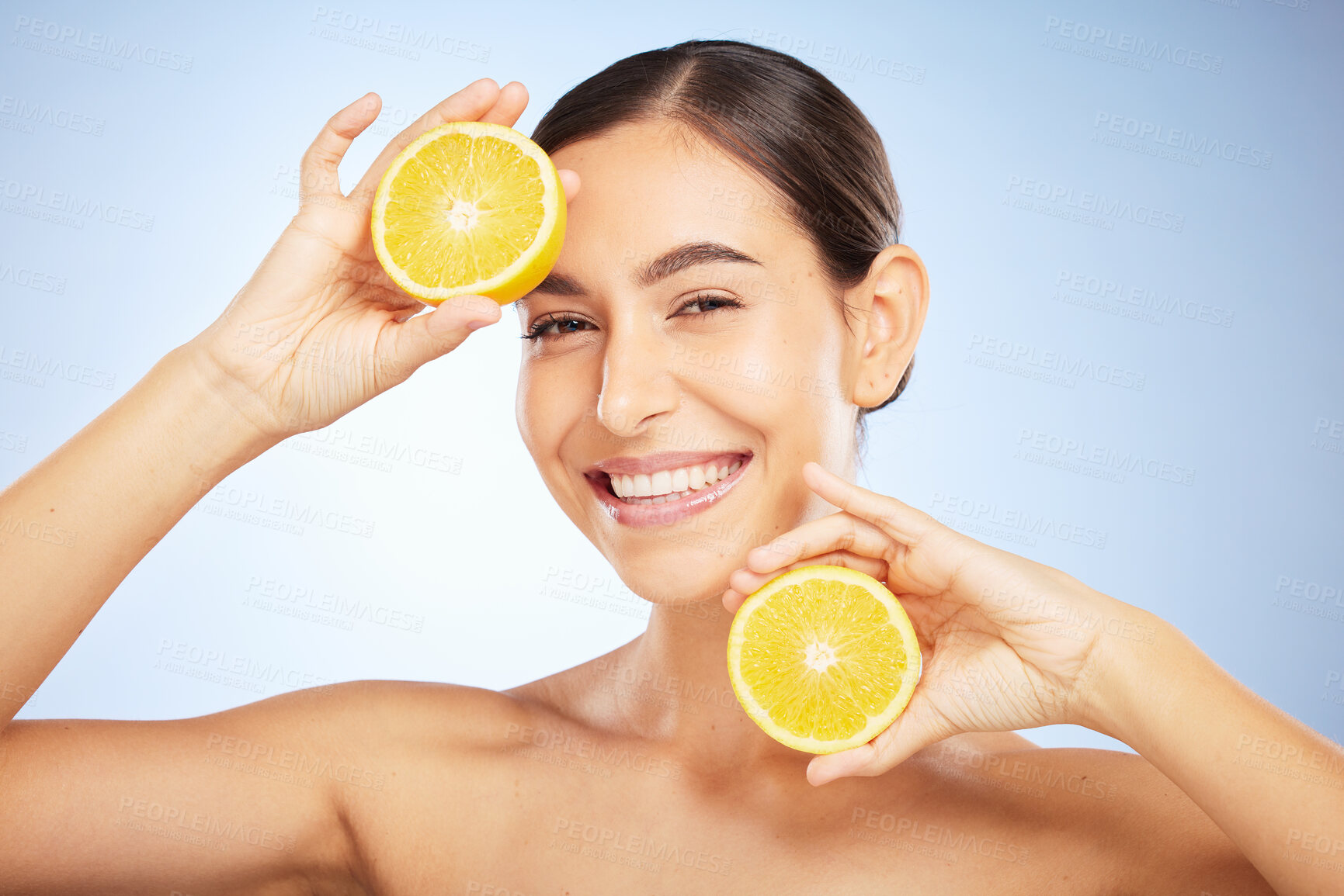 Buy stock photo Woman, skincare portrait and lemon for beauty, health and wellness with vitamin c, happy and smile. Model, fruit and happiness for self care, clean radiant glow and skin by blue background in studio