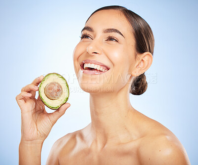 Buy stock photo Woman, face or skincare glow with avocado on blue background in studio healthcare wellness, grooming routine or organic food dermatology. Smile, happy or beauty model with diet fruit for relax facial