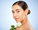 Face portrait, skincare and woman with flower in studio on a blue background mockup. Organic makeup, floral cosmetics and female model with white plant for facial treatment, healthy skin and beauty.
