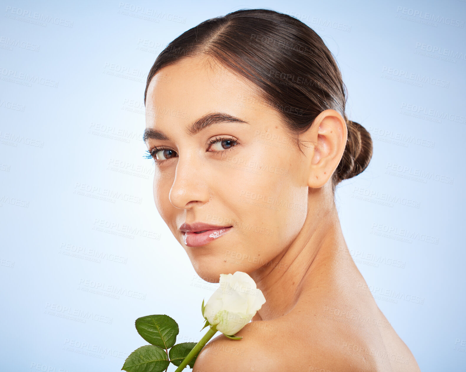Buy stock photo Face portrait, skincare and woman with flower in studio on a blue background mockup. Organic makeup, floral cosmetics and female model with white plant for facial treatment, healthy skin and beauty.