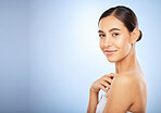 Portrait, skincare and beauty with a model woman in studio on a gray background for natural treatment. Face, wellness and luxury with an attractive young female posing to promote a skin care product