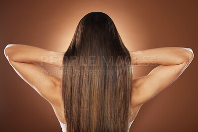 Buy stock photo Woman, back or hair style on brown background in relax studio for keratin treatment, self care wellness or color dye routine. Model, texture or brunette growth aesthetic with balayage transformation