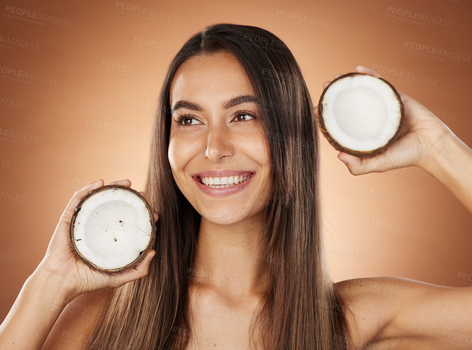 Buy stock photo Woman, skincare and coconut in studio, happy or smile for self care, nutrition or cosmetic health. Model, skin wellness and fruit for oil, moisturizer or cosmetics background for natural radiant glow