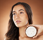 Coconut skincare beauty, woman and studio for health, wellness and natural radiant glow by backdrop. Model, face and fruit for nutrition, cosmetics or coconut oil for skin moisturizer by background