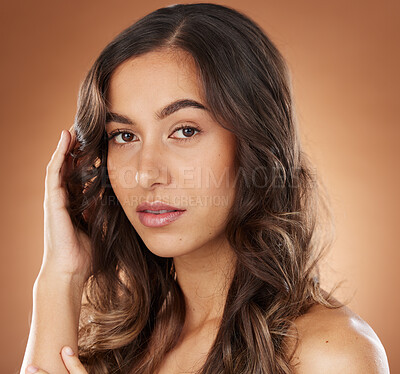 Buy stock photo Woman, face skincare or curly hairstyle on brown studio background in color dye advertising, self love or Brazilian keratin treatment. Portrait, beauty model or brunette waves and natural makeup glow