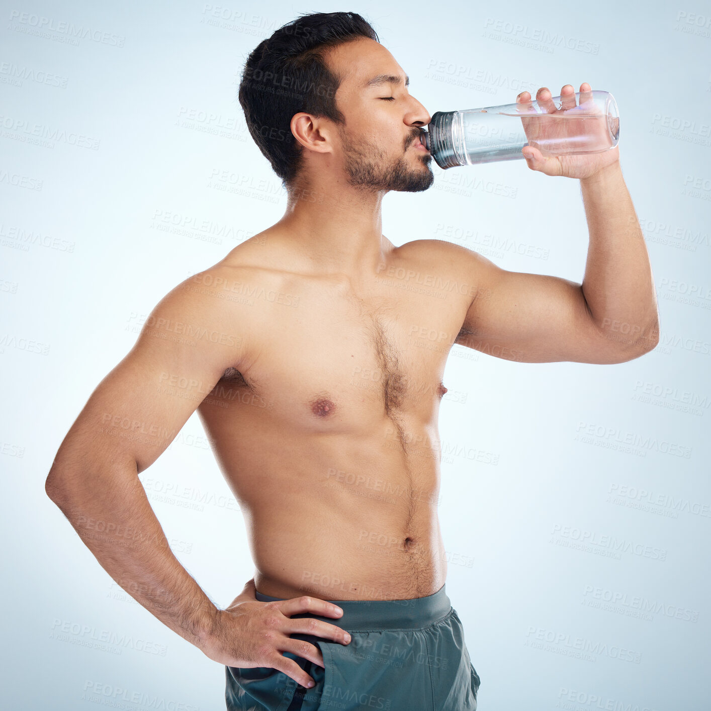 Buy stock photo Fitness, health or man drinking water in studio after training in workout or exercise for body goals or wellness. Motivation, weight loss or tired healthy person relaxing and drinks liquid or bottle