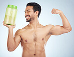 Fitness, man and protein powder for muscle gain, diet and weight loss on grey studio background. Male, athlete and body builder for sports nutrition container, supplement and healthy energy drink. 