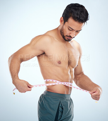 Buy stock photo Man, body or measuring tape on waist on studio background for weight loss management, fat control or bmi and diet wellness. Fitness model, sports athlete or coach with tape measure for muscle goals